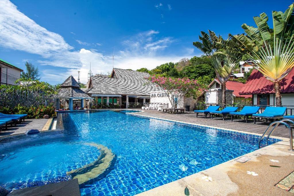 a swimming pool in front of a house at P.P. Casita - Adult Only in Phi Phi Islands