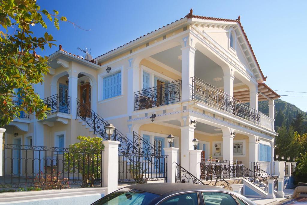 a large white house with a balcony at Prince Studios in Sami