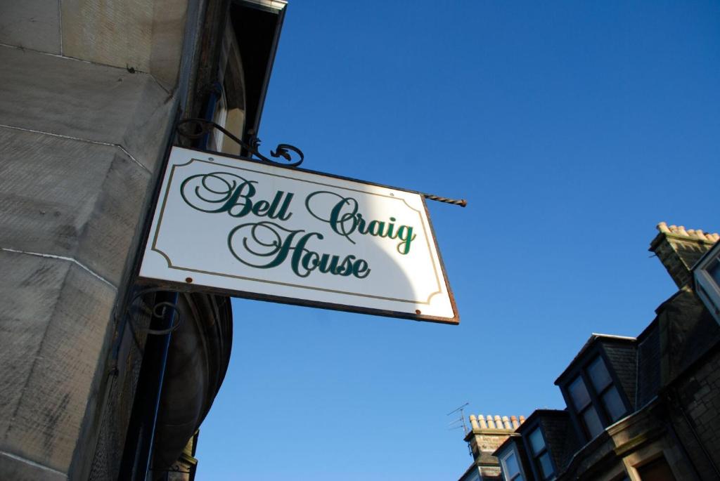 a sign for a bell charity house hanging on a building at BELL CRAIG GUEST HOUSE in Fife
