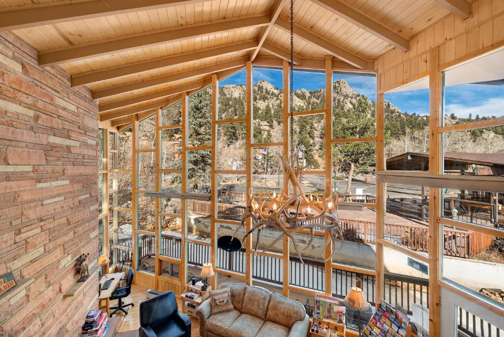 
a living room filled with furniture and a large window at Nicky's Resort in Estes Park
