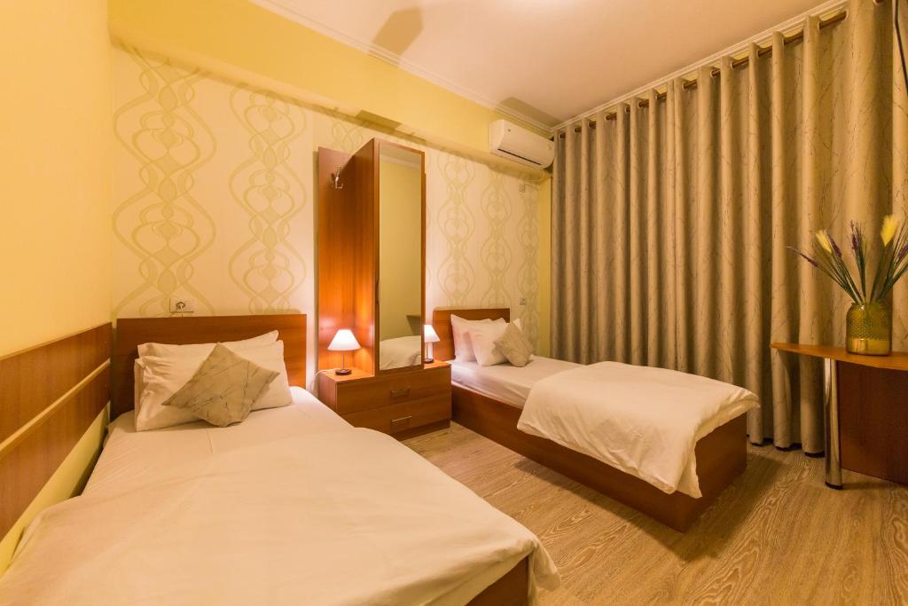 Postel nebo postele na pokoji v ubytování Hotel Baron