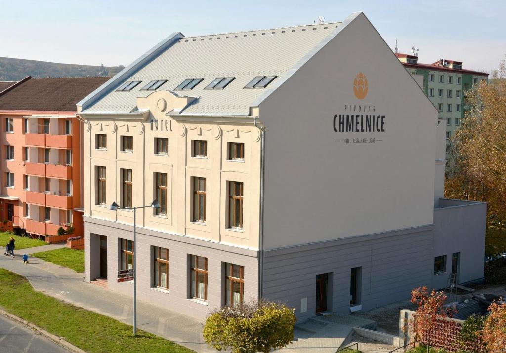 a white building with a sign on the side of it at hotel Chmelnice in Napajedla