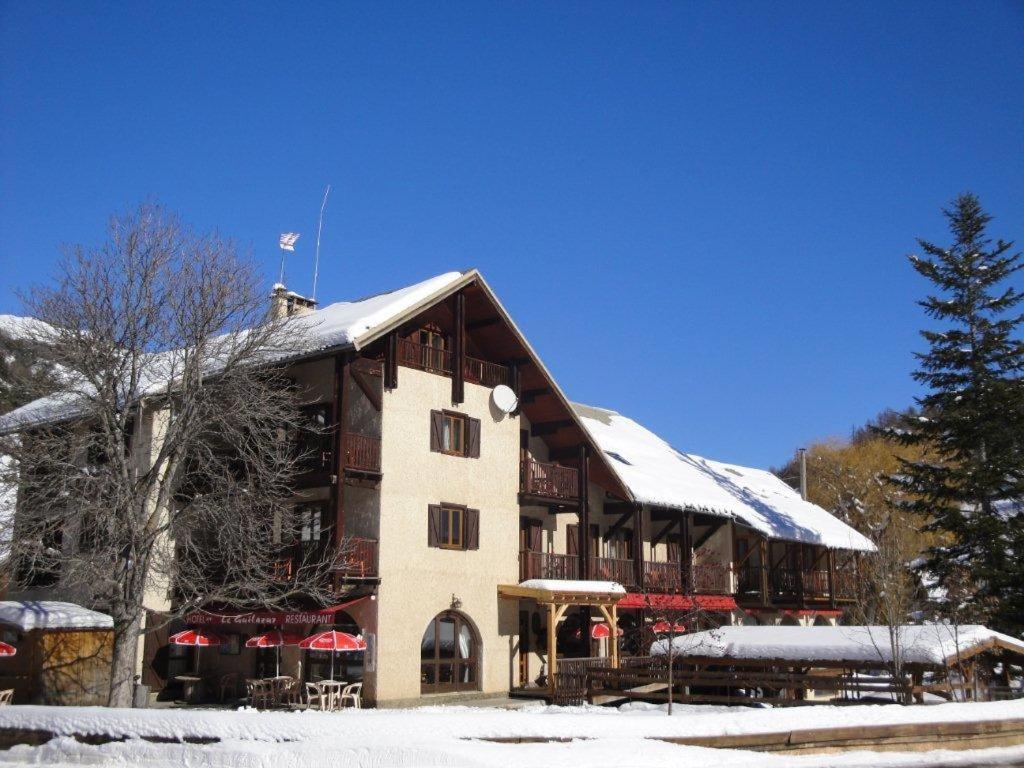 a large building with snow on top of it at Le Guilazur in Château-Ville-Vieille