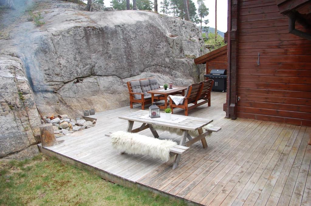 a wooden deck with a table and a sheep laying on it at Vrådal Panorama - Tiuråsvegen 39 in Vradal
