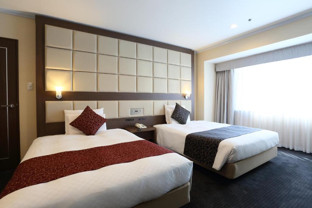 Postel nebo postele na pokoji v ubytování Loisir Hotel Toyohashi