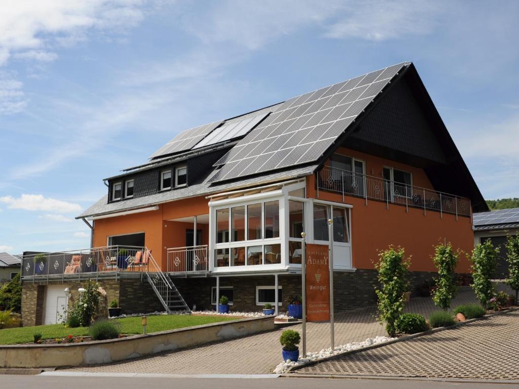 a house with solar panels on the roof at Ferienweingut Wolfgang Adamy in Kinheim