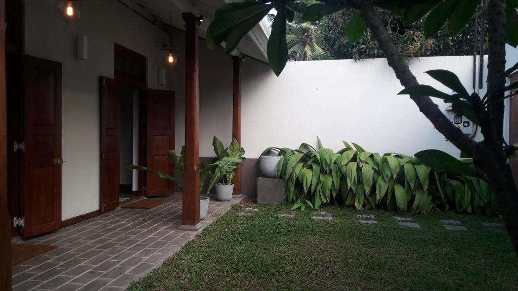 a house with a courtyard with plants and a door at Villa 35F in Galle
