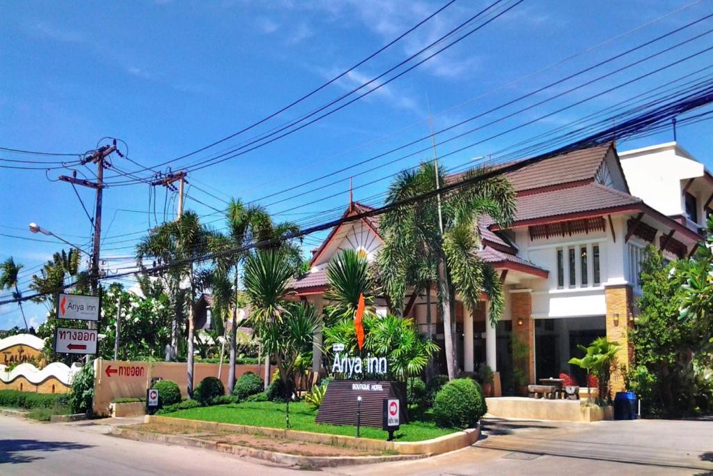 a building with a sign in front of it at Ariya inn Chiangrai in Chiang Rai