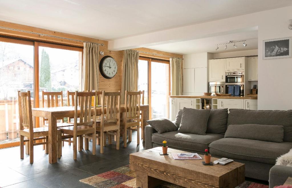 a living room with a couch and a table at Chalet Marmotte 2 in Morzine