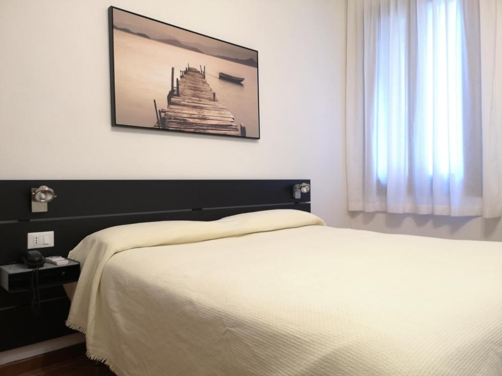 Postel nebo postele na pokoji v ubytování Hotel Rossi