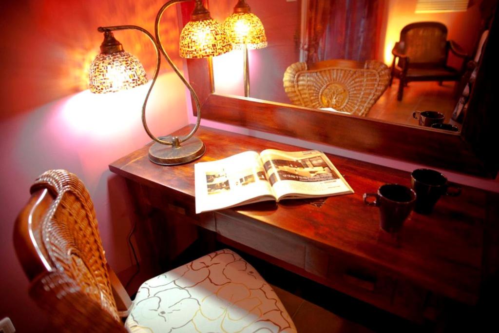 a desk with a lamp and a book on it at Alongs Garden in Hengchun South Gate