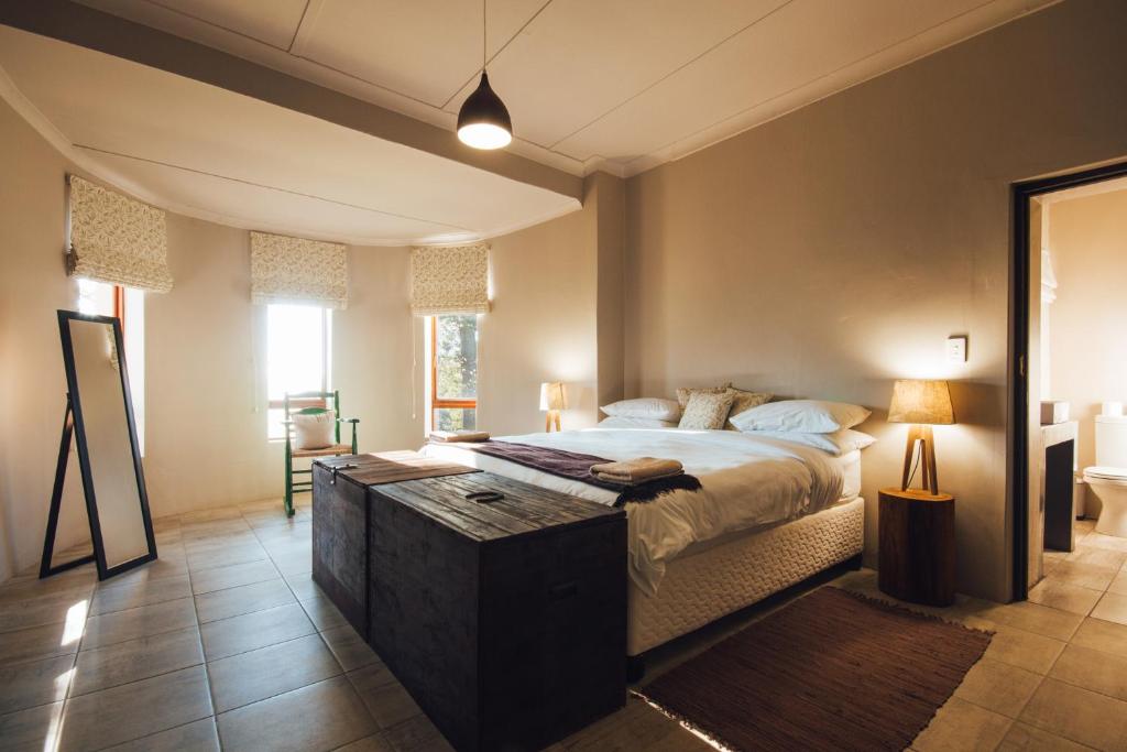 a bedroom with a large bed with a wooden table at Strawberry Hill Farm in Heidelberg