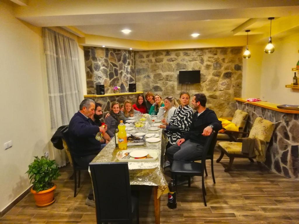 a group of people sitting at a dinner table at Guest House on Meskheti in Borjomi