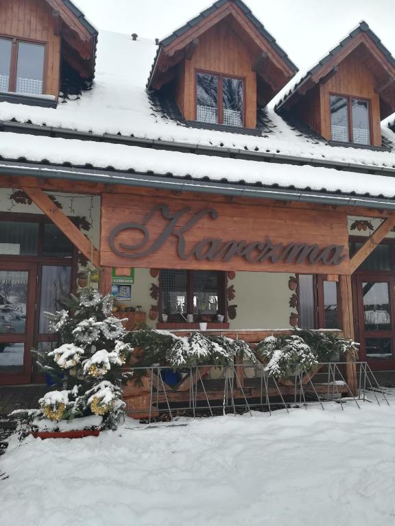 a log cabin with snow on the roof at Dwa Dęby in Lubawka