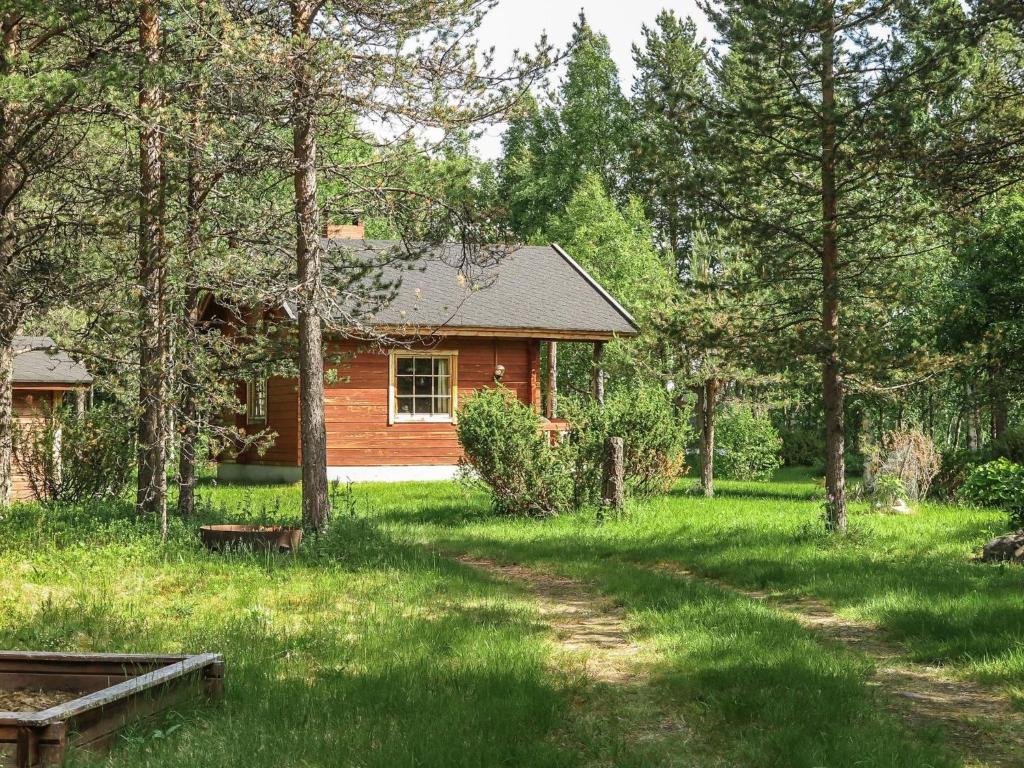 a cabin in the woods with a dirt road in front at Holiday Home Anula by Interhome in Sodankylä