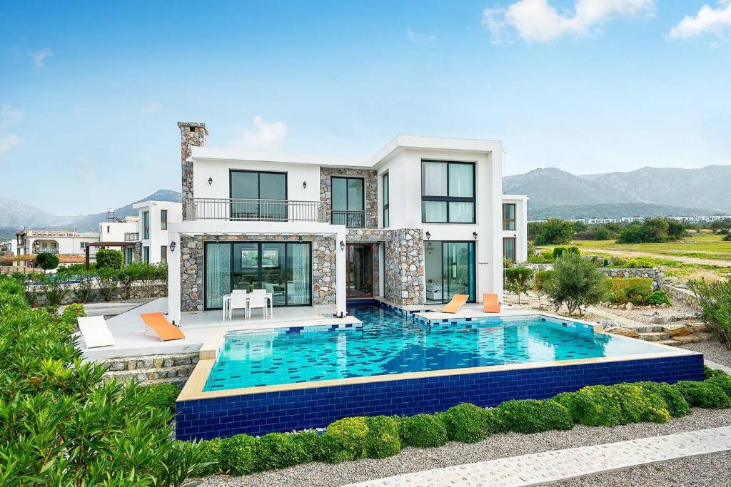 a house with a swimming pool in front of it at Joya Cypern Seaside Luxurious Villa and Private Pool in Akanthou
