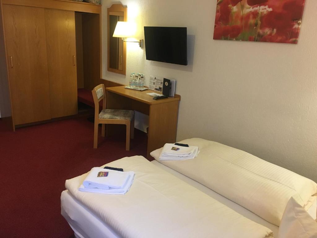 Postel nebo postele na pokoji v ubytování Hotel & Restaurant Druidenstein