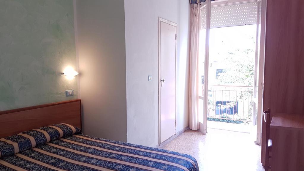 Postel nebo postele na pokoji v ubytování Hotel Promenade Universale