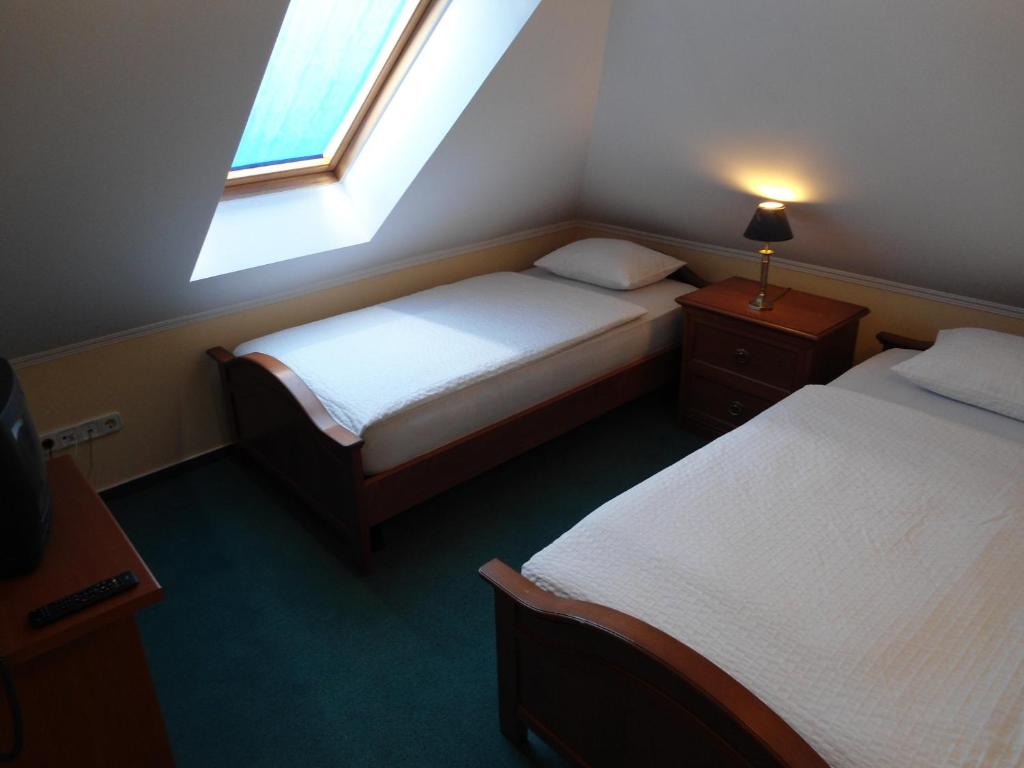 Postel nebo postele na pokoji v ubytování Platán Hotel