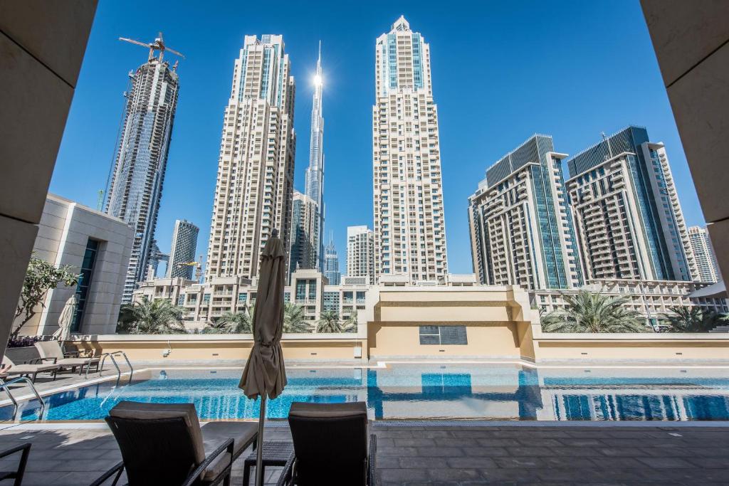 a swimming pool with a city skyline in the background at bnbmehomes - Elegant & Stylish Studio in Downtown - 502 in Dubai