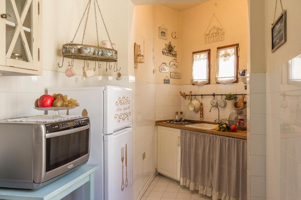 a small kitchen with a refrigerator and a sink at Casa Laura in Florence
