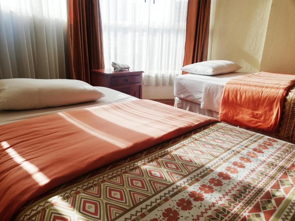 Postel nebo postele na pokoji v ubytování Hostal Capri