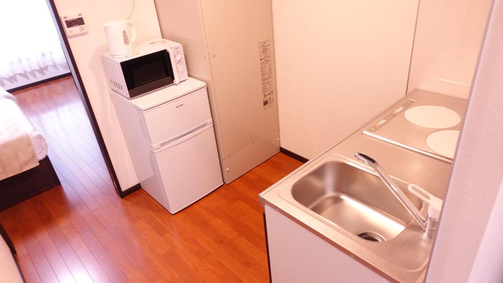 Kuchyň nebo kuchyňský kout v ubytování COCORO HOTEL