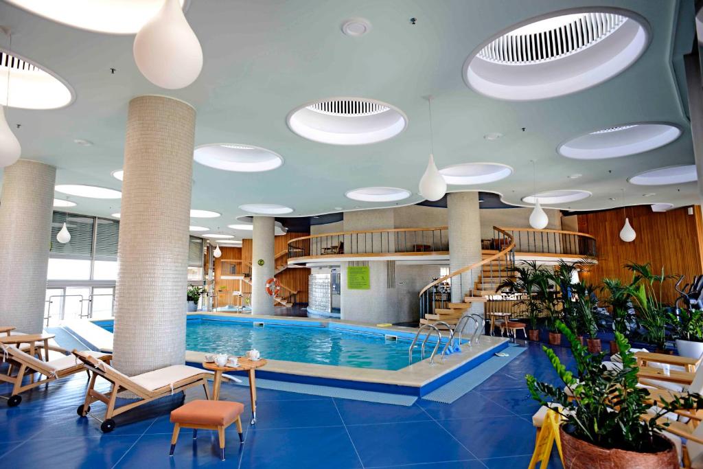 
a large swimming pool in a large room at Grand Hotel Bucharest in Bucharest

