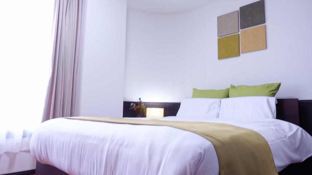 Postel nebo postele na pokoji v ubytování COCORO HOTEL