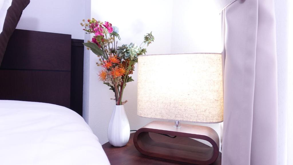 Postel nebo postele na pokoji v ubytování COCORO HOTEL