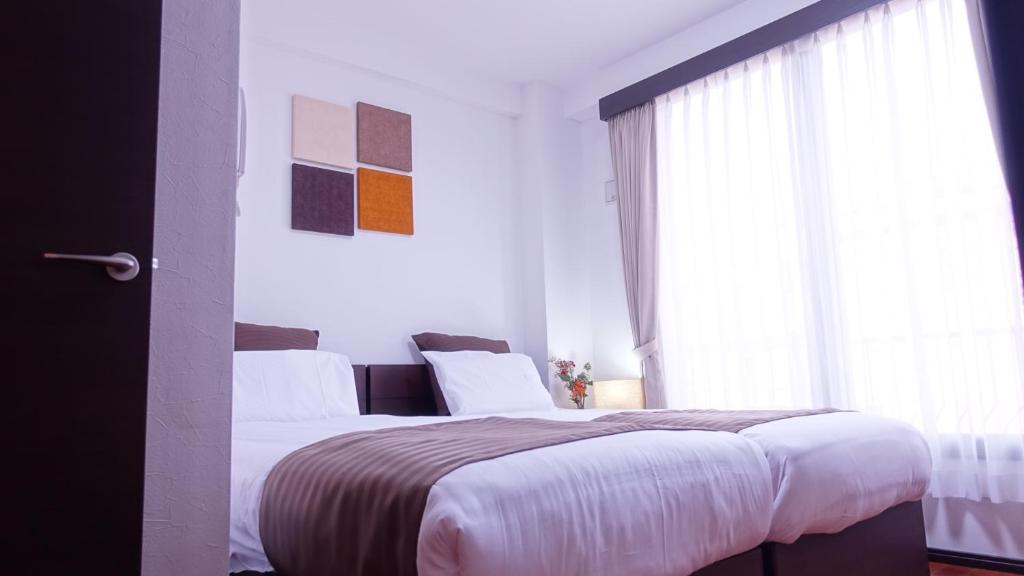 Postel nebo postele na pokoji v ubytování COCORO HOTEL