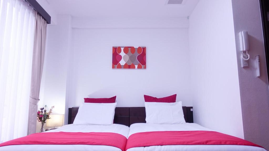 Postel nebo postele na pokoji v ubytování COCORO HOTEL