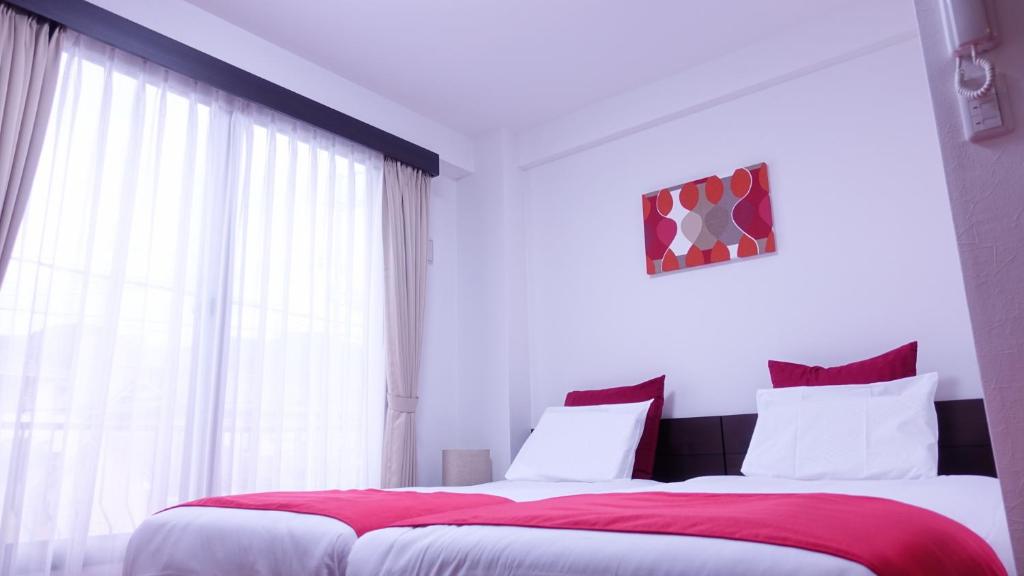 Postel nebo postele na pokoji v ubytování COCORO HOTEL