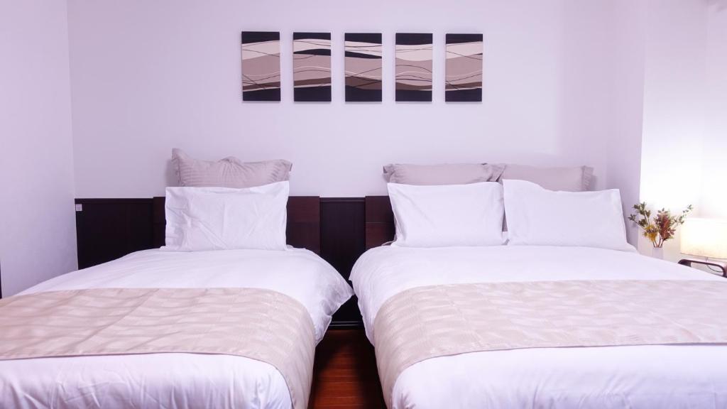 Postel nebo postele na pokoji v ubytování COCORO HOTEL
