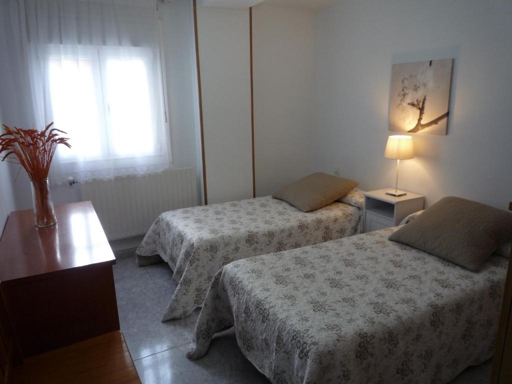Cama o camas de una habitación en Hostal Residencia Ponte Vella