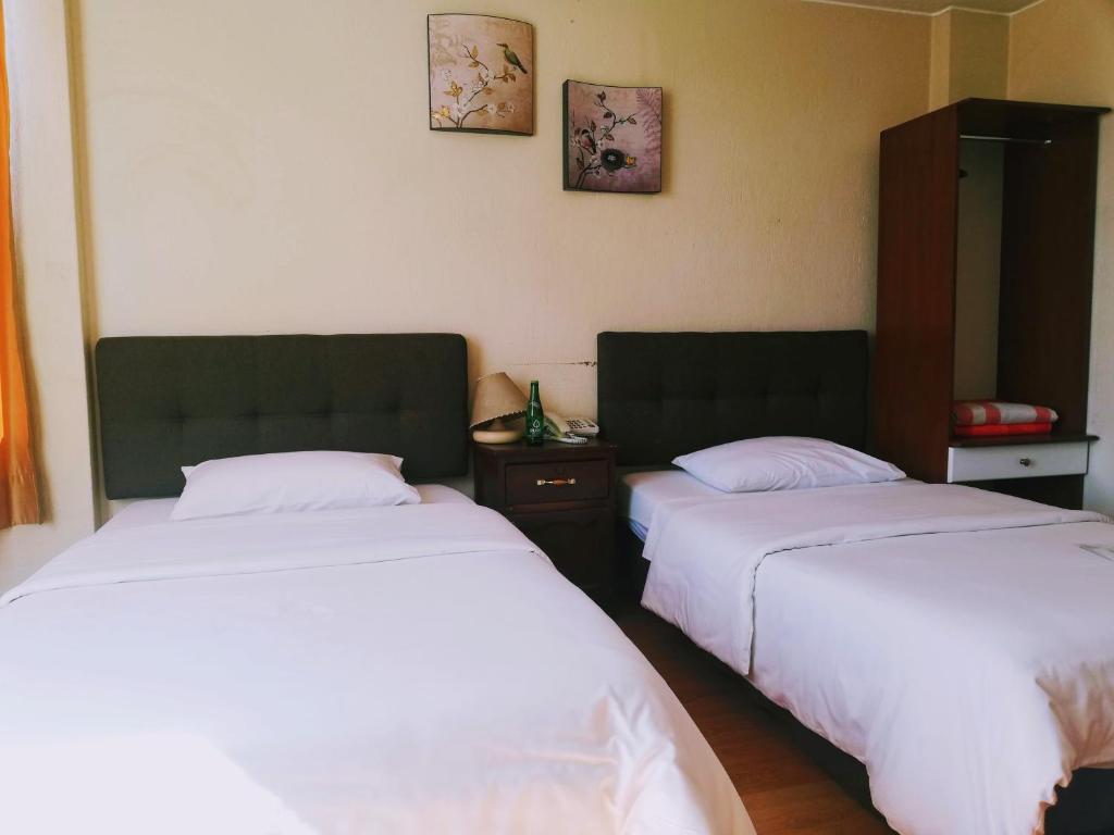 Postel nebo postele na pokoji v ubytování Hostal Capri
