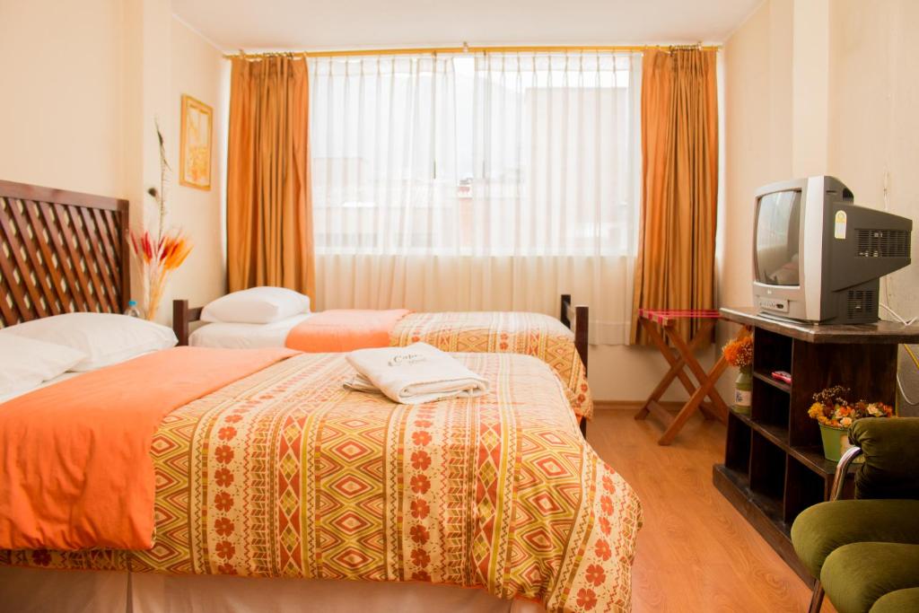 Postel nebo postele na pokoji v ubytování Hostal Capri