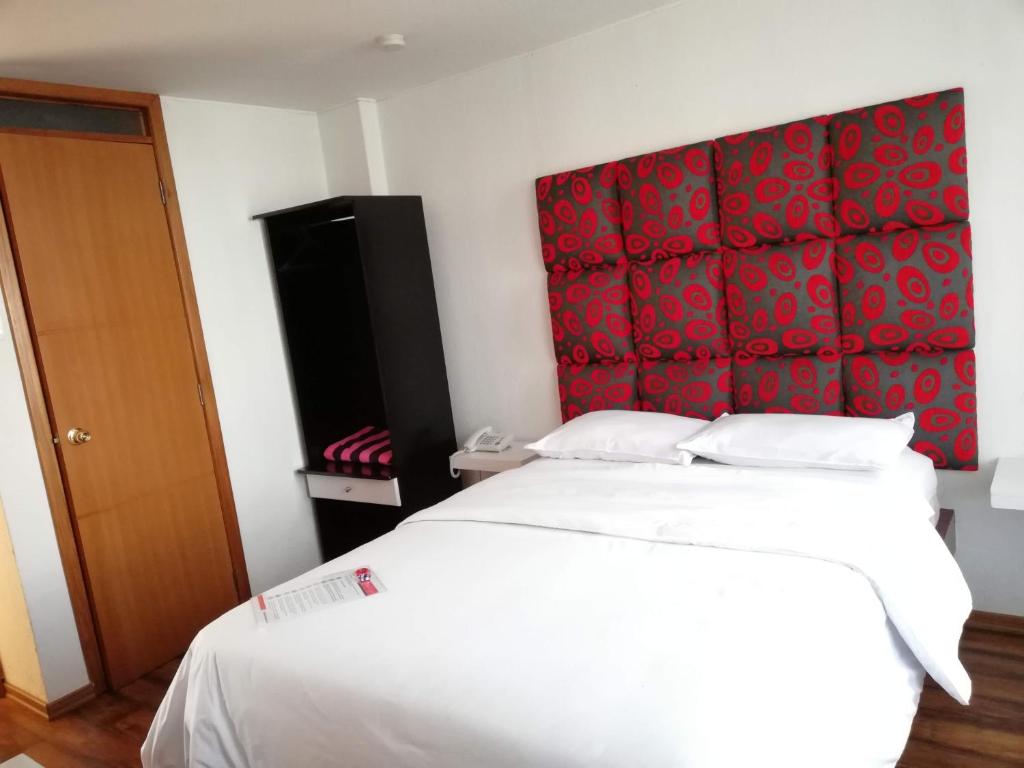 Postel nebo postele na pokoji v ubytování Hostal Capri