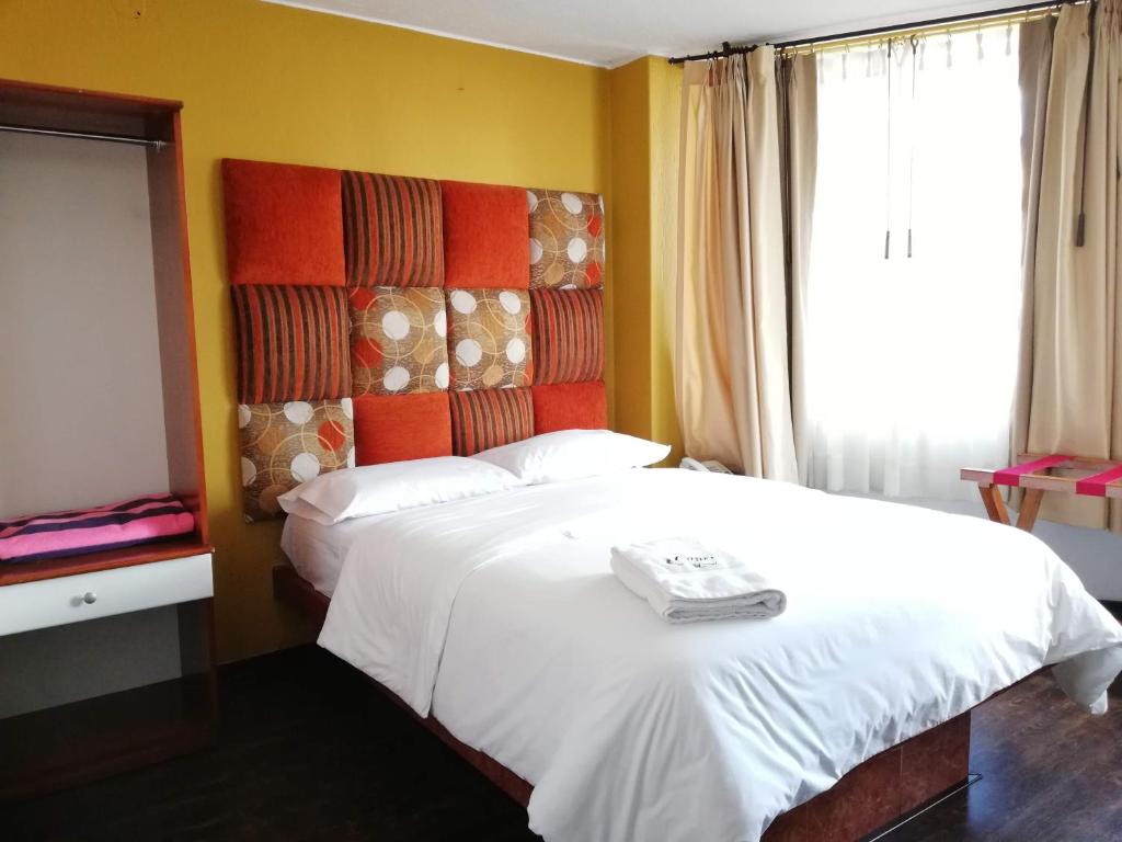 Postel nebo postele na pokoji v ubytování Hostal Capri
