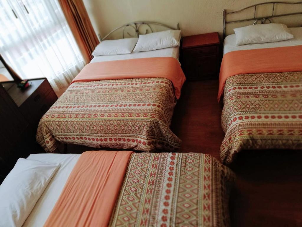 Postel nebo postele na pokoji v ubytování Hostal Capri
