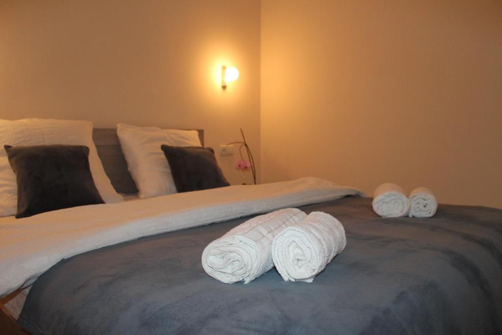 a bed with three rolled up towels on it at Rooms 3 in Stepantsminda