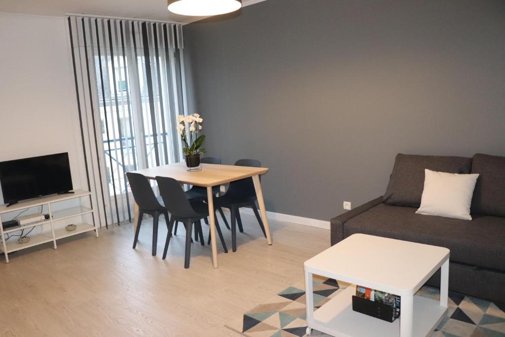 uma sala de estar com um sofá e uma mesa em STUDIO CENTRE VILLE COMPIÈGNE em Compiègne