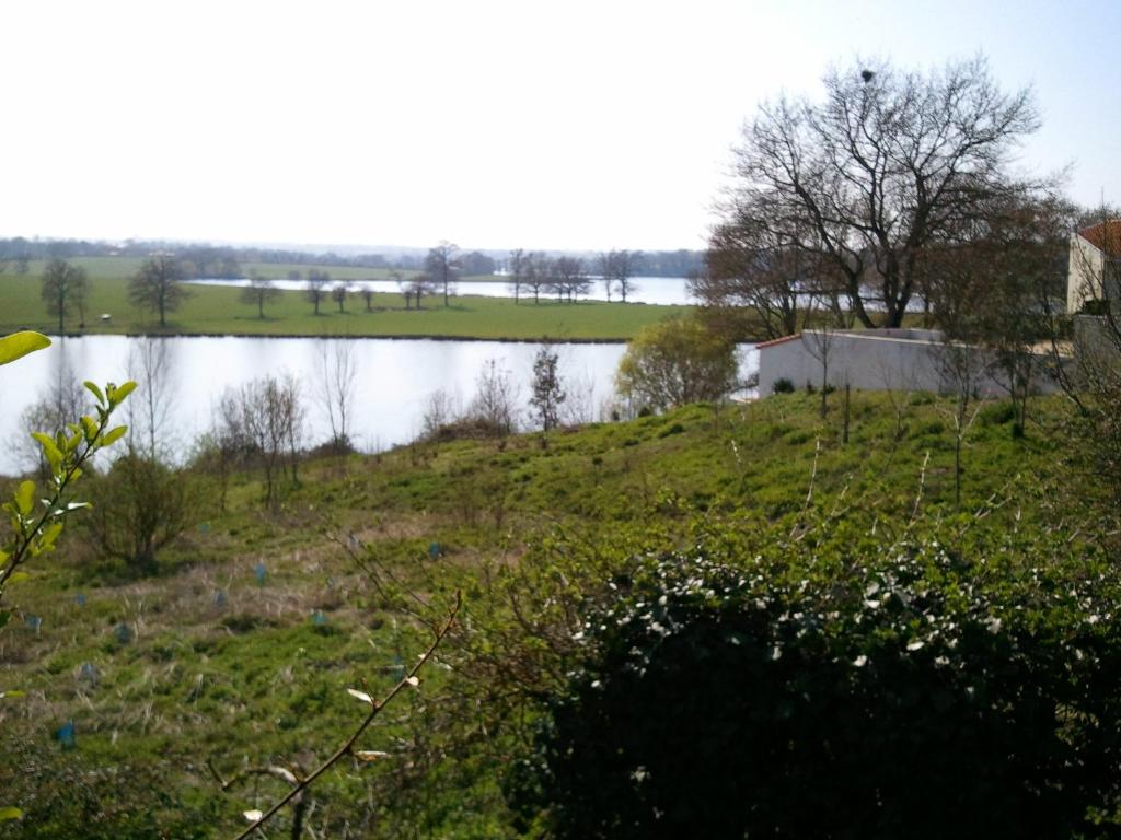 a view of a body of water with a field at Mas du Trezon in Cholet