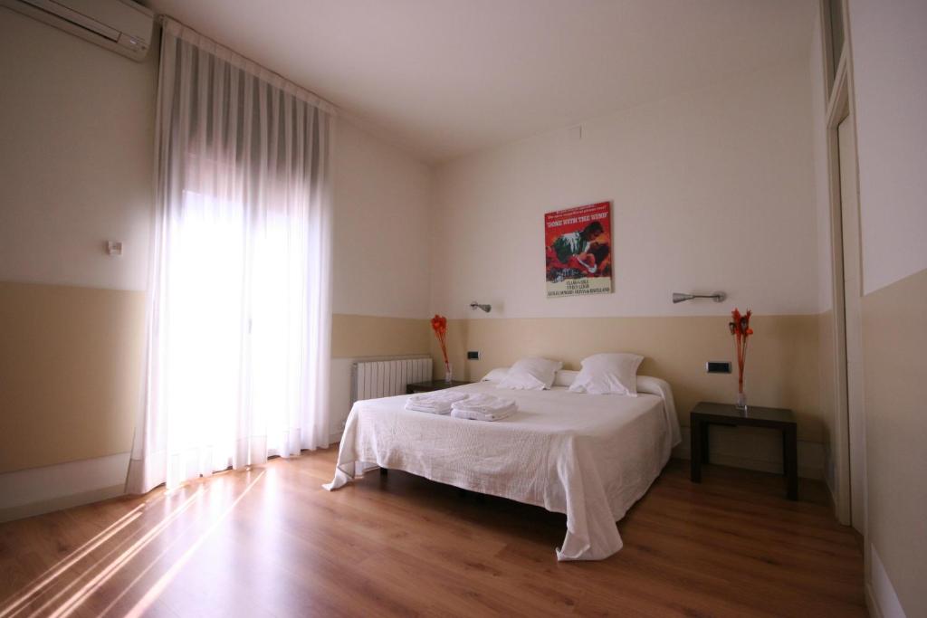 a bedroom with a white bed and a large window at Az Barcelona Center in Barcelona