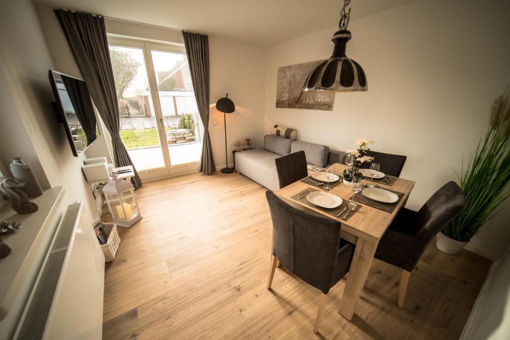 a living room with a table and a couch at Haus Sonnenterrasse in Westerland