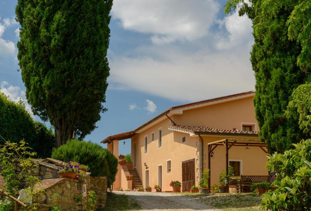 a large house with trees in front of it at Agriturismo Pretenzano in Volterra