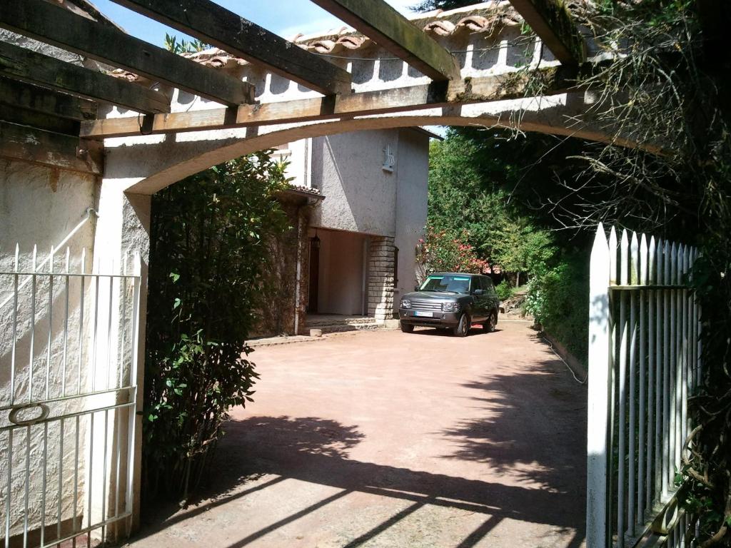 a car parked under an archway in a driveway at Mas du Trezon in Cholet