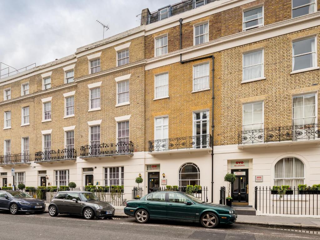 a green car parked in front of a brick building at Belgravia Rooms Hotel in London