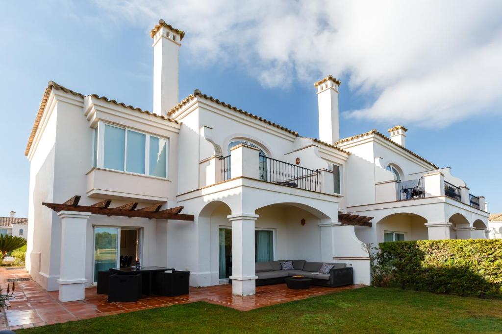 a large white house with a balcony at Arcos Gardens Sol Rent Golf in Arcos de la Frontera