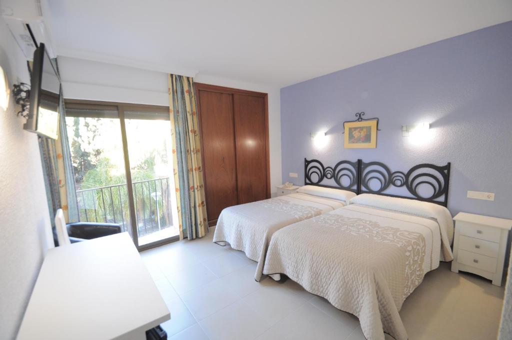 Postel nebo postele na pokoji v ubytování Hotel Goya